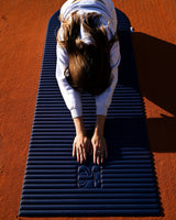 Session sport lifestyle avec tapis de sol Hercule Studio Archy navy, tapis premium bleu nuit pour pilates, étirements et entraînement au sol
