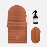 Hercule Studio terracotta essential bundle including the Archy arch-shaped sport mat, the Galé 3-in-1 comfort pad for knees and elbows and the sanitizing spray, durable Made in France Pilates and fitness bundle, packshot of grouped products