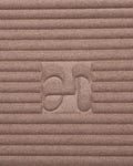 Close-up on the beige cashmere texture and embossed H logo of the Hercule Studio x From Future Sandy Brown sport mat