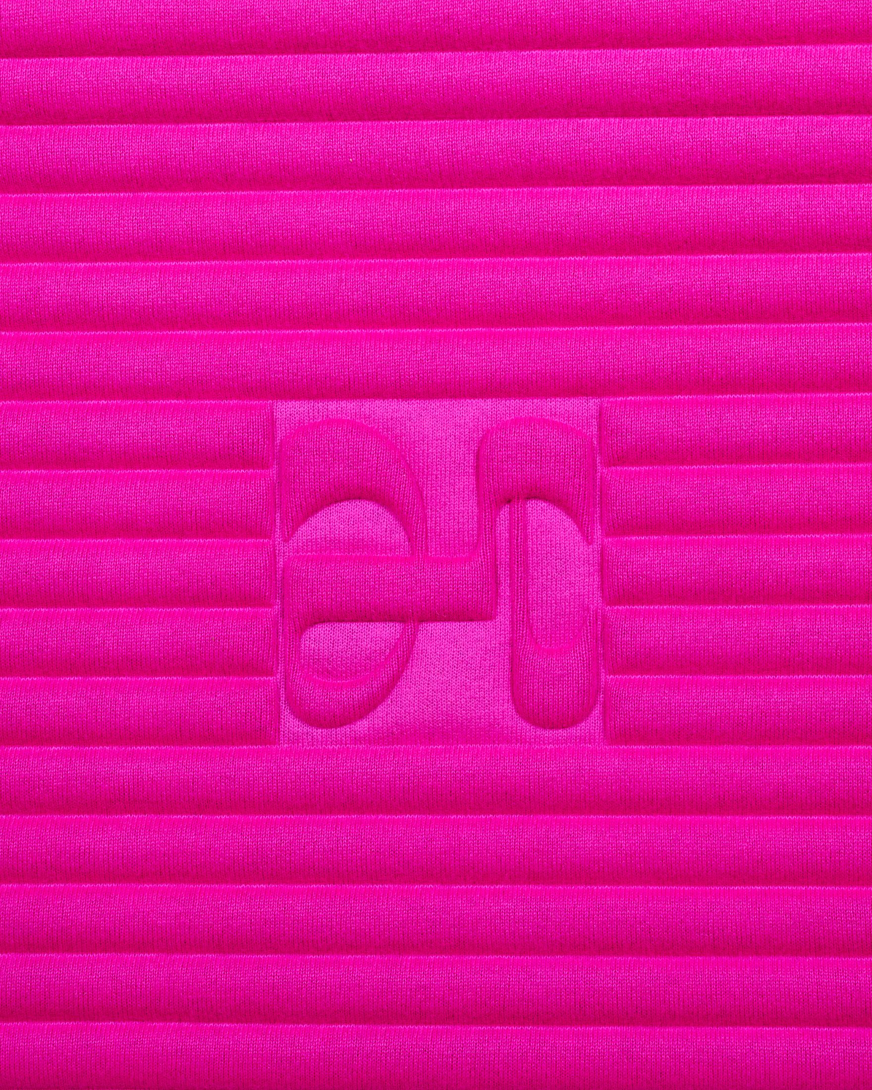 Close-up on the fuchsia pink cashmere texture and embossed H logo of the Hercule Studio x From Future Candy Pink sport mat