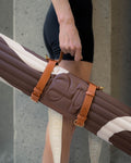Archy exercise mat in Bari Choco color by Hercule Studio, with a Soca carrying strap made of vegetable-tanned leather