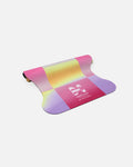 Half-rolled packshot of the Hercule Studio Dance Out yoga mat, colorful suede design mat, limited edition for modern yoga practice
