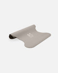Half-rolled view of the Hercule Studio Greige yoga mat, PVC-free, eco-friendly, comfort and performance for all postures
