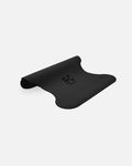 Half-rolled view of the Midnight Black yoga mat, made in France, PVC-free, wavy texture for stability and alignment