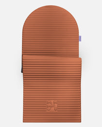 Hercule Studio Archy terracotta arch-shaped sport mat, durable premium Made in France exercise mat for fitness, Pilates and stretching, half unrolled view